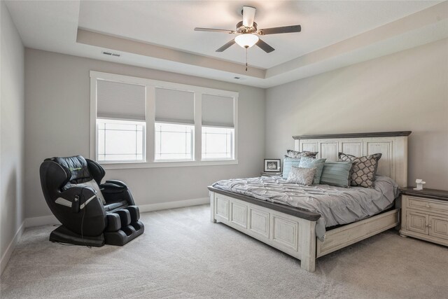2920 Oak St, Norwalk, IA 50211 - bedroom with light carpet, a raised ceiling, and a ceiling fan
