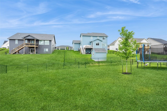 2920 Oak St, Norwalk, IA 50211 - fenced backyard with a trampoline, a residential view, stairway, and a deck
