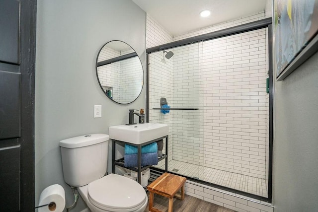 305 E 20th St S, Newton, IA 50208 - bathroom with a shower stall, wood finished floors, and recessed lighting