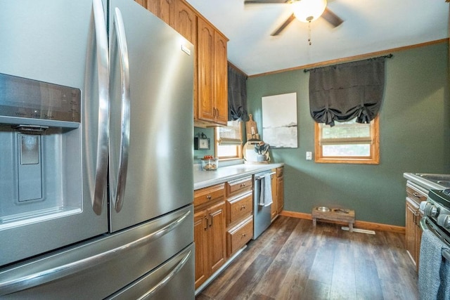 305 E 20th St S, Newton, IA 50208 - kitchen with appliances with stainless steel finishes, brown cabinets, healthy amount of natural light, and dark wood-style floors
