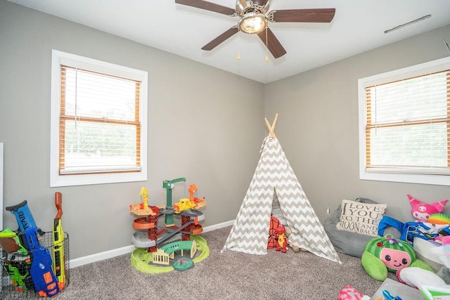 305 E 20th St S, Newton, IA 50208 - recreation room featuring healthy amount of natural light, carpet flooring, and ceiling fan