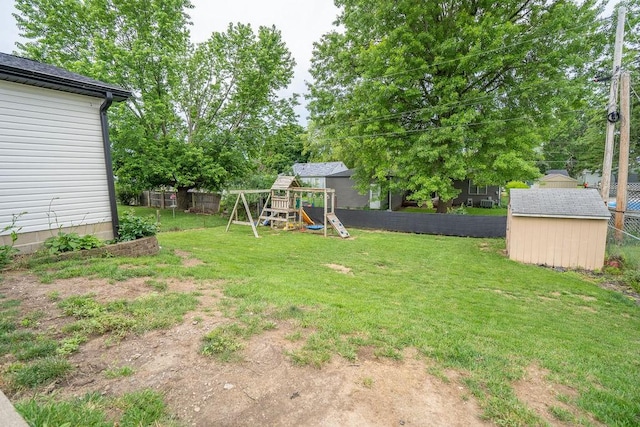 305 E 20th St S, Newton, IA 50208 - fenced backyard featuring a playground and a shed