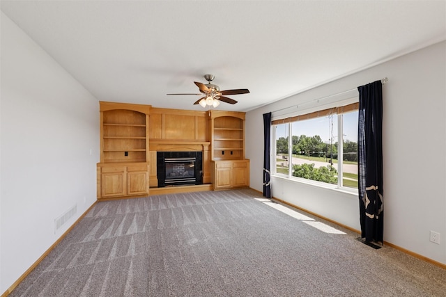 7039 Carey Ct, Johnston, IA 50131 - unfurnished living room with a ceiling fan, a glass covered fireplace, and light colored carpet