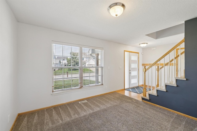 7039 Carey Ct, Johnston, IA 50131 - carpeted foyer entrance featuring stairs and baseboards
