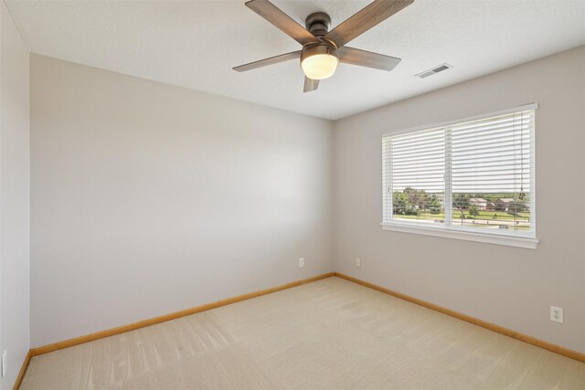 7039 Carey Ct, Johnston, IA 50131 - unfurnished room featuring light carpet and a ceiling fan