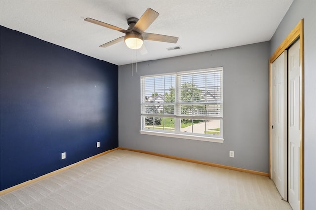7039 Carey Ct, Johnston, IA 50131 - unfurnished bedroom with carpet, a closet, and ceiling fan