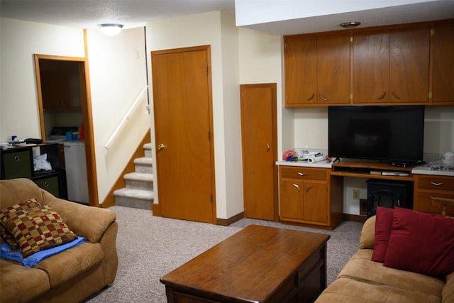 205 E 23rd St N, Newton, IA 50208 - living area featuring built in study area, light colored carpet, and stairs