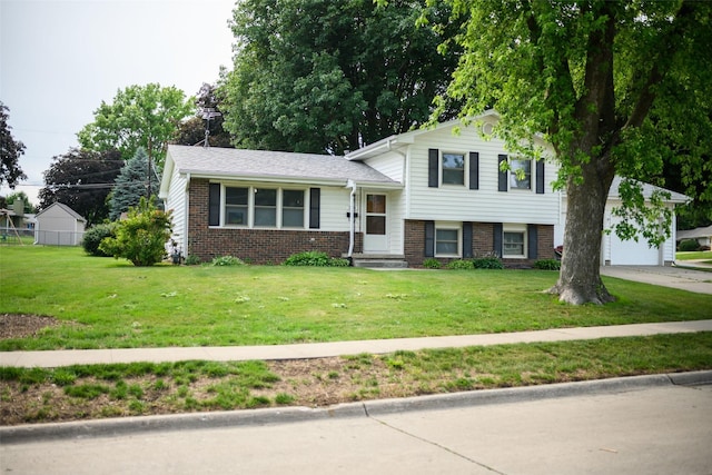 205 E 23rd St N, Newton, IA 50208 - tri-level home featuring brick siding, a front lawn, an attached garage, and driveway