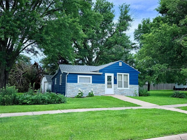 2003 Carroll St, Boone, IA 50036 - ranch-style house with stone siding, a shingled roof, and an outbuilding