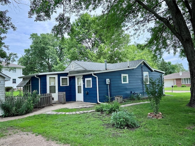 2003 Carroll St, Boone, IA 50036 - rear view of house featuring a lawn and a patio area