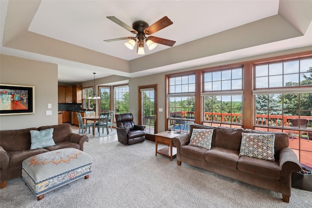 940 High Ave, Newton, IA 50208 - living area with a raised ceiling, a ceiling fan, and carpet
