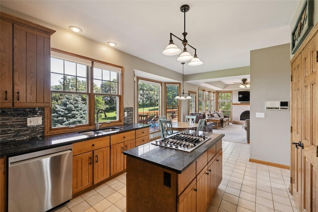 940 High Ave, Newton, IA 50208 - kitchen with appliances with stainless steel finishes, open floor plan, light tile patterned floors, hanging light fixtures, and recessed lighting