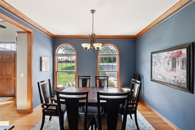 940 High Ave, Newton, IA 50208 - dining room with a chandelier, healthy amount of natural light, light wood-style flooring, and ornamental molding