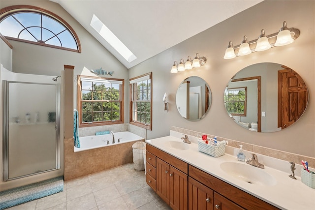 940 High Ave, Newton, IA 50208 - full bathroom featuring a skylight, plenty of natural light, double vanity, and high vaulted ceiling