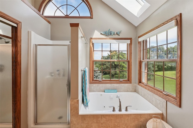 940 High Ave, Newton, IA 50208 - bathroom featuring a skylight, a stall shower, a jetted tub, healthy amount of natural light, and lofted ceiling