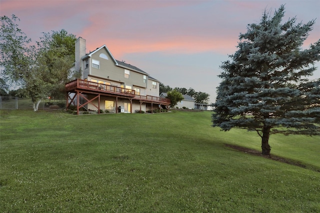 940 High Ave, Newton, IA 50208 - back of property at dusk with a deck and a chimney