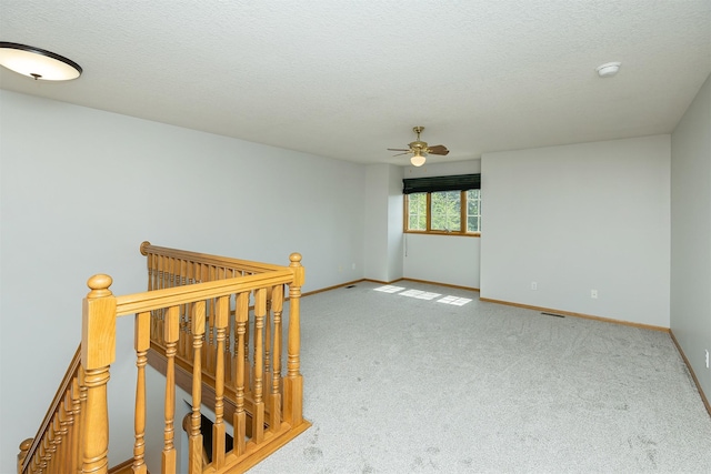 1560 Castlegar Ct, Pleasant Hill, IA 50327 - spare room featuring ceiling fan, carpet flooring, a smoke detector, and a textured ceiling