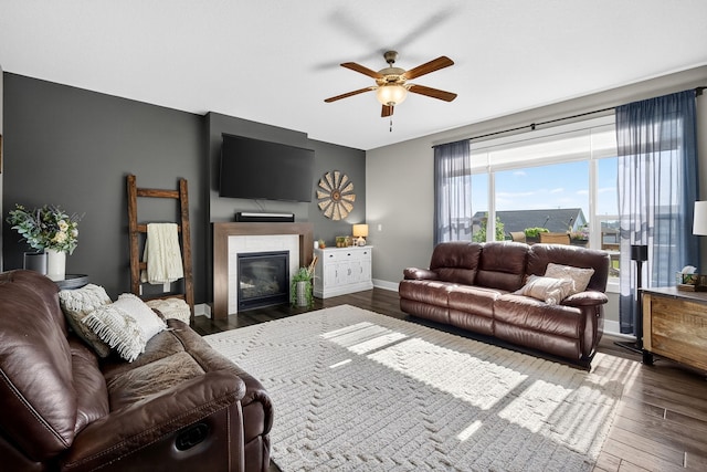 5519 165th St, Urbandale, IA 50323 - living area featuring wood finished floors, ceiling fan, and a glass covered fireplace