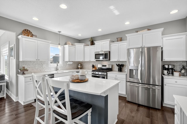 5519 165th St, Urbandale, IA 50323 - kitchen featuring appliances with stainless steel finishes, white cabinets, a center island, and recessed lighting