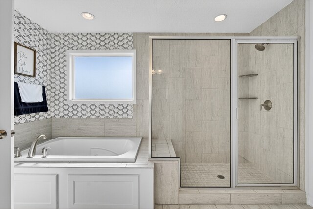 5519 165th St, Urbandale, IA 50323 - full bath featuring a bath, a shower stall, and recessed lighting