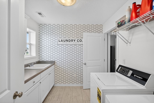 5519 165th St, Urbandale, IA 50323 - washroom with washer and clothes dryer and cabinet space