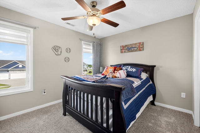 5519 165th St, Urbandale, IA 50323 - bedroom with multiple windows, carpet floors, and ceiling fan