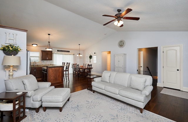 358 S 85th St, West Des Moines, IA 50266 - living room featuring dark wood-style floors, vaulted ceiling, and ceiling fan