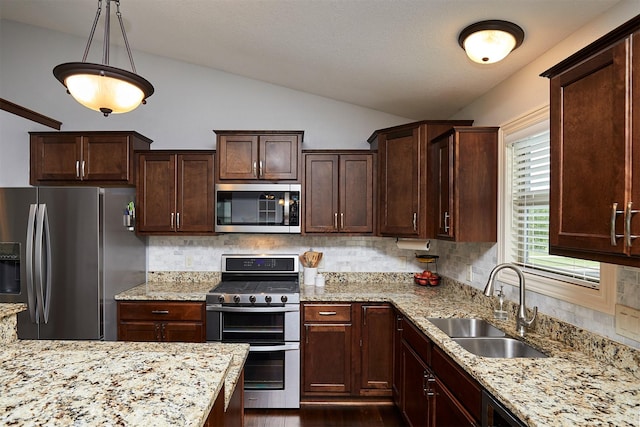 358 S 85th St, West Des Moines, IA 50266 - kitchen with stainless steel appliances, vaulted ceiling, decorative backsplash, light stone countertops, and dark brown cabinetry