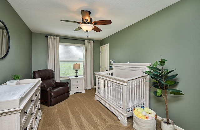 358 S 85th St, West Des Moines, IA 50266 - carpeted bedroom featuring a crib and ceiling fan