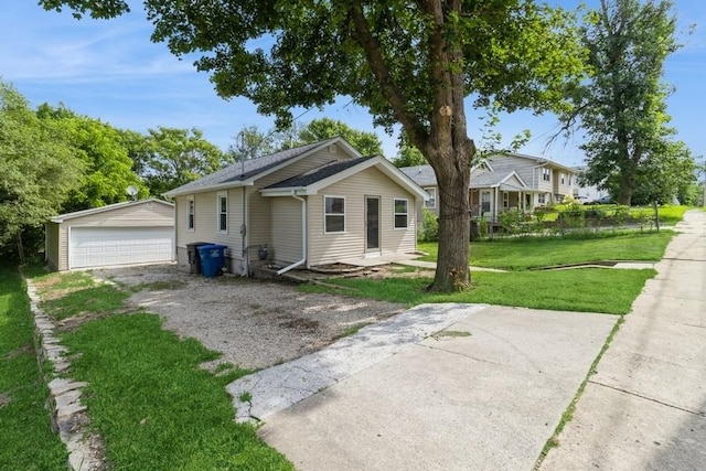 8 E Wall Ave, Des Moines, IA 50315 - view of front of house featuring a garage, a front lawn, and an outdoor structure