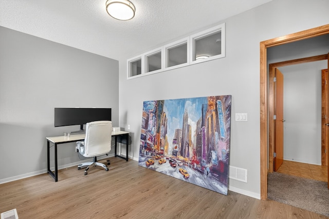 640 S 50th St Unit 2204, West Des Moines, IA 50265 - home office featuring wood finished floors and a textured ceiling