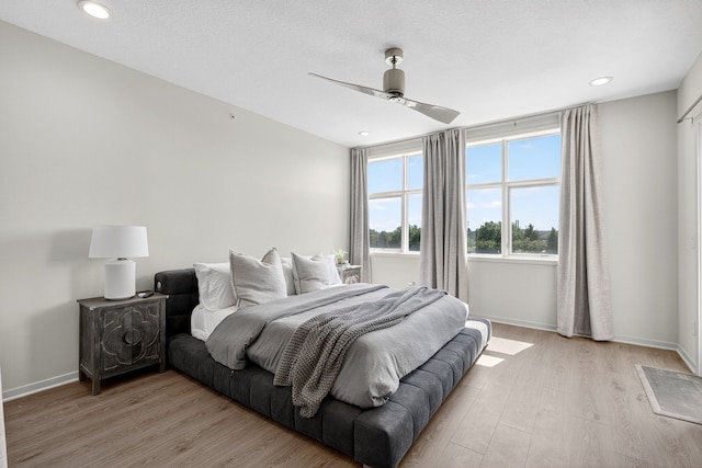 640 S 50th St Unit 2204, West Des Moines, IA 50265 - bedroom featuring light wood finished floors, a ceiling fan, and recessed lighting