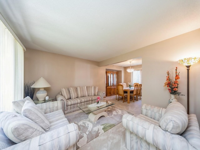 3436 Valley View Dr, West Des Moines, IA 50265 - carpeted living room with a chandelier