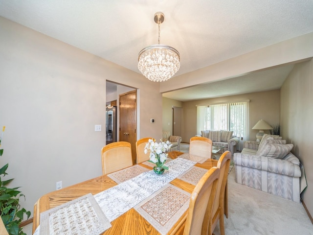 3436 Valley View Dr, West Des Moines, IA 50265 - dining area featuring a chandelier and carpet