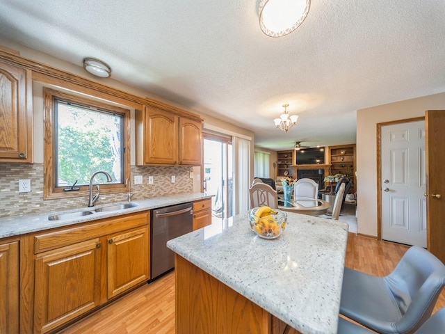 3436 Valley View Dr, West Des Moines, IA 50265 - kitchen featuring dishwasher, a textured ceiling, brown cabinetry, a chandelier, and decorative backsplash