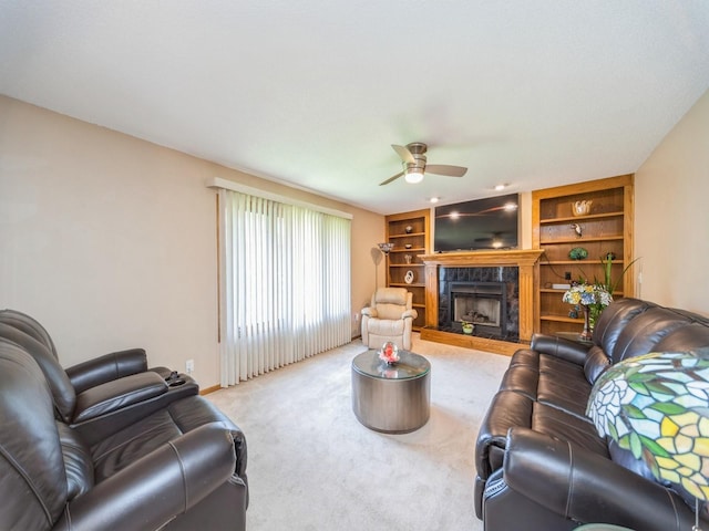 3436 Valley View Dr, West Des Moines, IA 50265 - living room featuring a ceiling fan, carpet, built in shelves, and a tiled fireplace