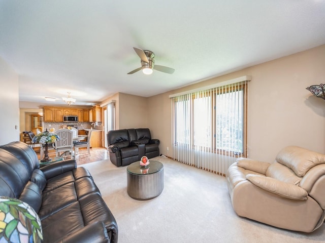 3436 Valley View Dr, West Des Moines, IA 50265 - living area with a ceiling fan, a chandelier, and light colored carpet