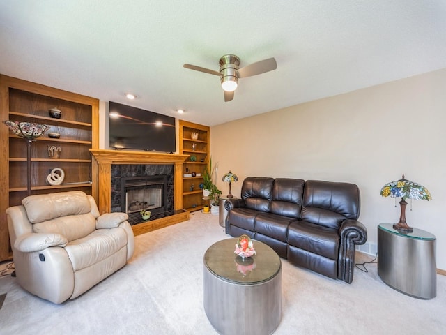 3436 Valley View Dr, West Des Moines, IA 50265 - carpeted living area with ceiling fan, a tiled fireplace, and built in shelves