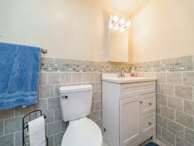 3436 Valley View Dr, West Des Moines, IA 50265 - half bath with tile walls, vanity, and wainscoting
