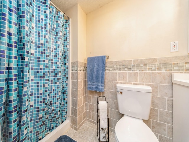 3436 Valley View Dr, West Des Moines, IA 50265 - bathroom with a textured ceiling, tile walls, a wainscoted wall, a shower with shower curtain, and vanity