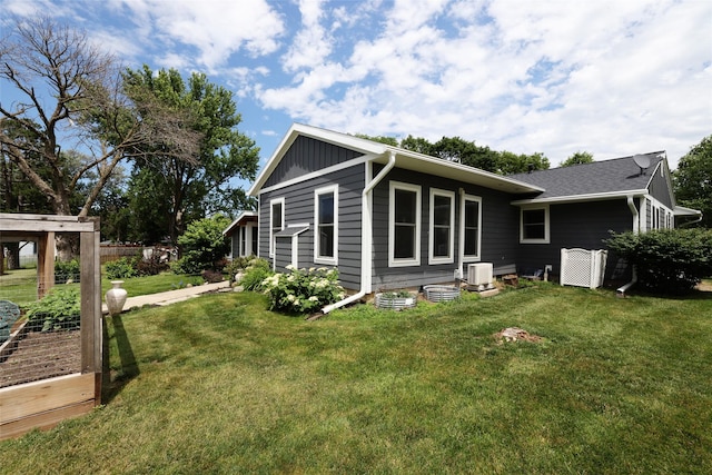 344 S 1st St, Ogden, IA 50212 - view of side of property with a lawn, board and batten siding, and a garden