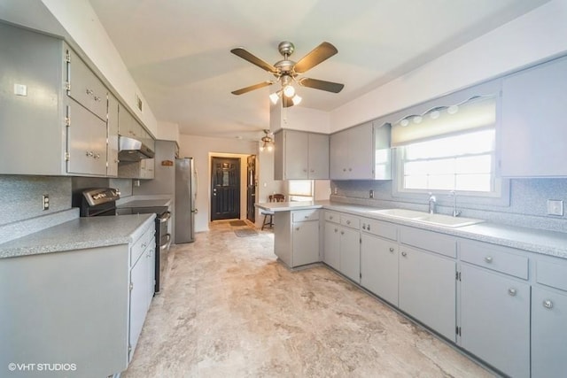 1805 Sycamore St, Granger, IA 50109 - kitchen featuring stainless steel appliances, under cabinet range hood, ceiling fan, light countertops, and a peninsula