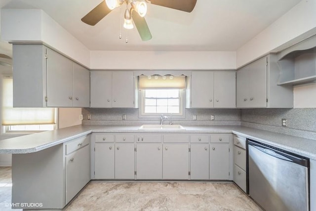 1805 Sycamore St, Granger, IA 50109 - kitchen with dishwasher, a ceiling fan, a peninsula, and backsplash