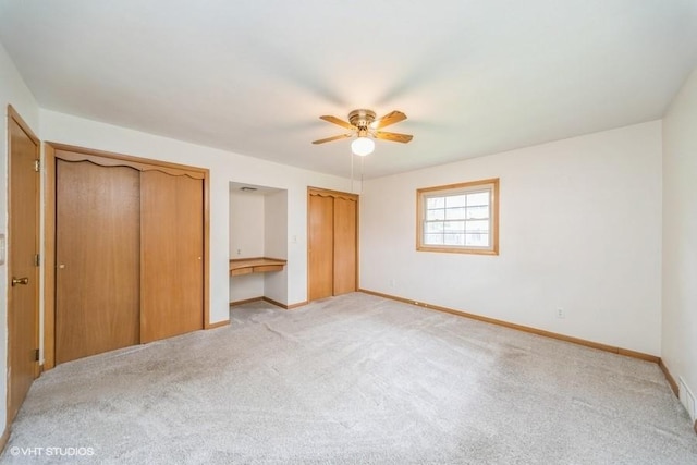 1805 Sycamore St, Granger, IA 50109 - unfurnished bedroom featuring multiple closets, light carpet, and ceiling fan