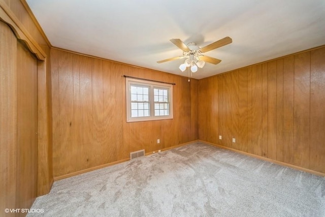 1805 Sycamore St, Granger, IA 50109 - empty room with ceiling fan, carpet floors, and wood walls