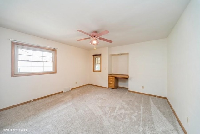 1805 Sycamore St, Granger, IA 50109 - spare room with carpet flooring, ceiling fan, and built in desk