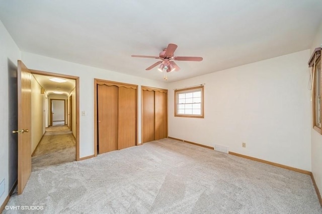 1805 Sycamore St, Granger, IA 50109 - unfurnished bedroom featuring multiple closets, light colored carpet, and ceiling fan
