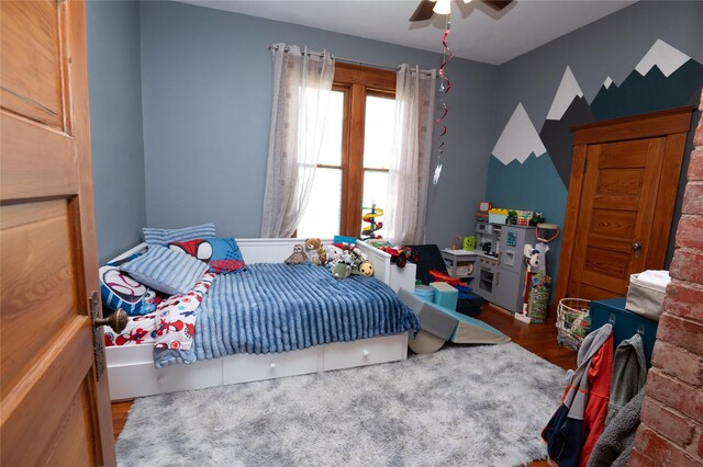 210 3rd St NE, Mitchellville, IA 50169 - bedroom with wood finished floors and a ceiling fan
