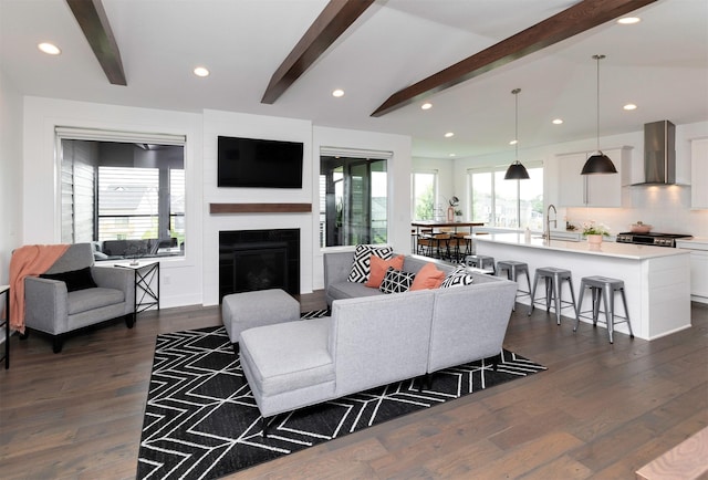 9138 Moonseed Ct, West Des Moines, IA 50266 - living area featuring dark wood-style floors, a glass covered fireplace, and recessed lighting