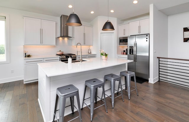 9138 Moonseed Ct, West Des Moines, IA 50266 - kitchen with wall chimney exhaust hood, stainless steel appliances, dark wood finished floors, a breakfast bar area, and decorative backsplash